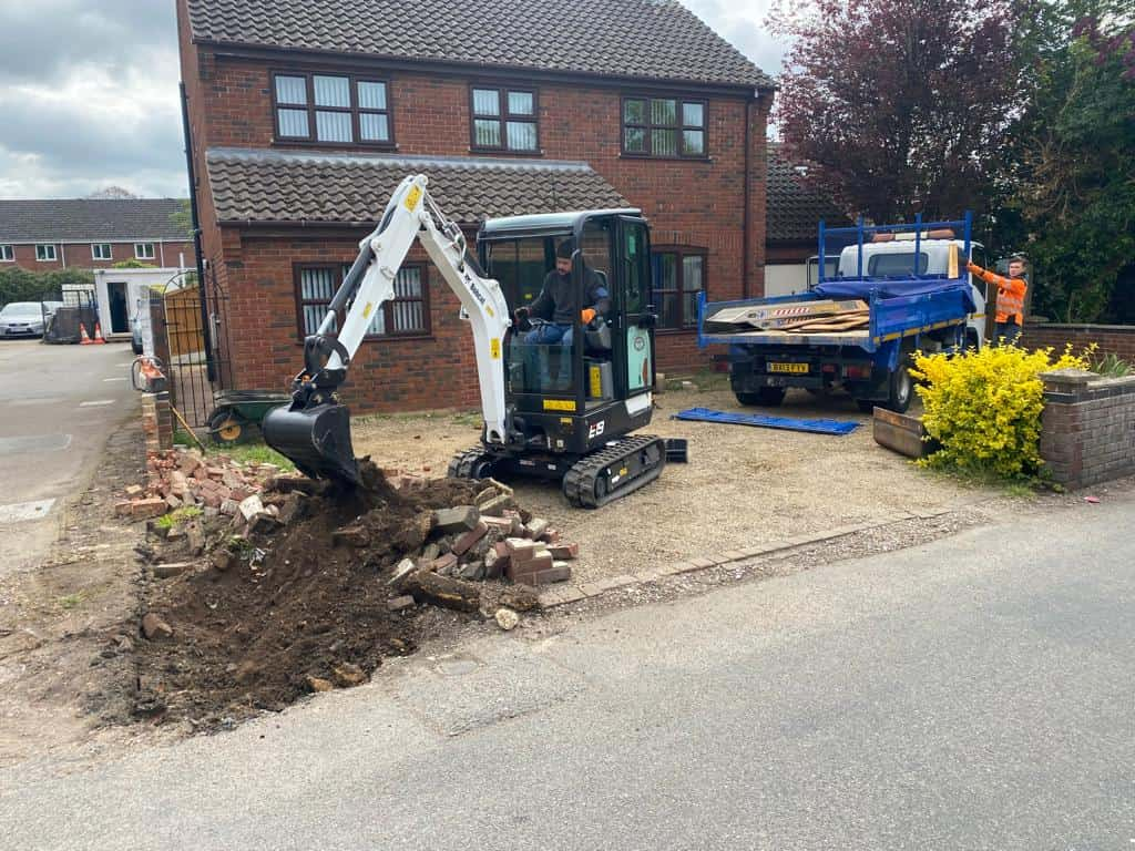 This is a photo of an operative of NS Driveways Caterham Digging out for a new tarmac driveway